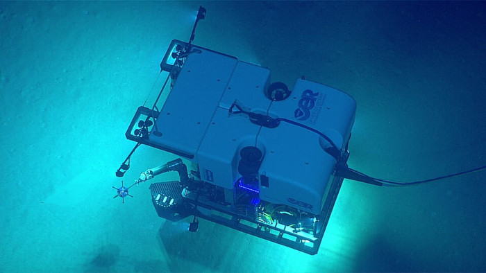 A remotely operated vehicle (ROV) equipped with high-powered lights and cameras is descending into the uncharted depths. 